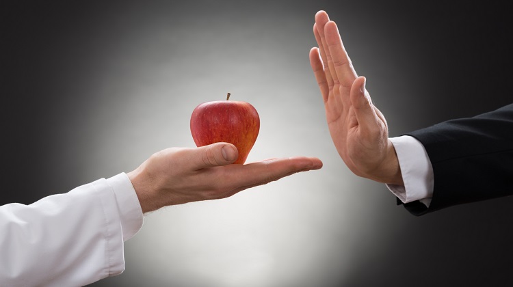 Person Refusing Apple Held By Doctor